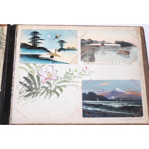 598 - An early 20th century Japanese black lacquer and Shibayama inlaid photograph album containing photog... 