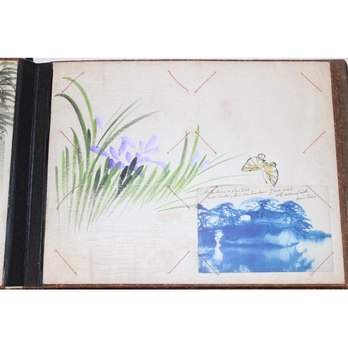 598 - An early 20th century Japanese black lacquer and Shibayama inlaid photograph album containing photog... 