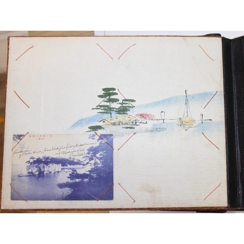 598 - An early 20th century Japanese black lacquer and Shibayama inlaid photograph album containing photog... 