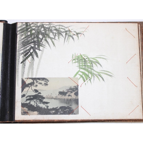 598 - An early 20th century Japanese black lacquer and Shibayama inlaid photograph album containing photog... 