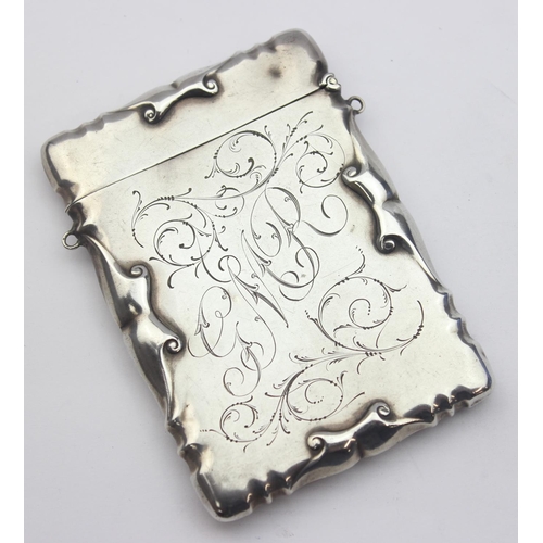 1004 - An Edwardian silver visiting card case with engraved name 