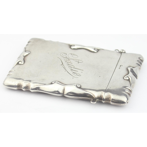 1004 - An Edwardian silver visiting card case with engraved name 