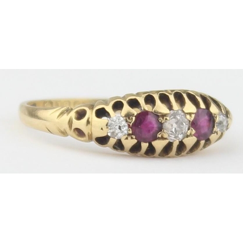 1102 - An antique diamond and ruby set ring, a central diamond assessed as approx 0.25ct flanked by 2 rubie... 