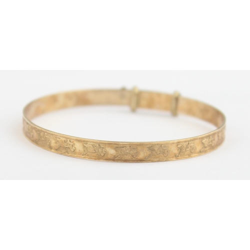 1108 - A 9ct gold expanding christening bangle decorated with storks, marked for 9ct gold and XRF confirmed... 