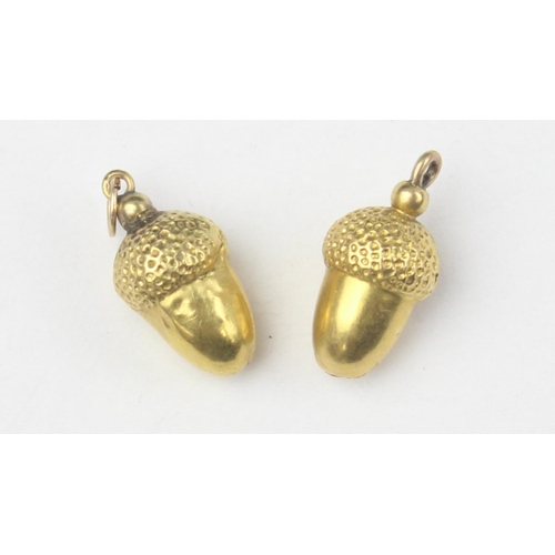 1128 - 2 yellow metal pendants or charms formed as acorns, seemingly unmarked but XRF testing as 18ct gold,... 