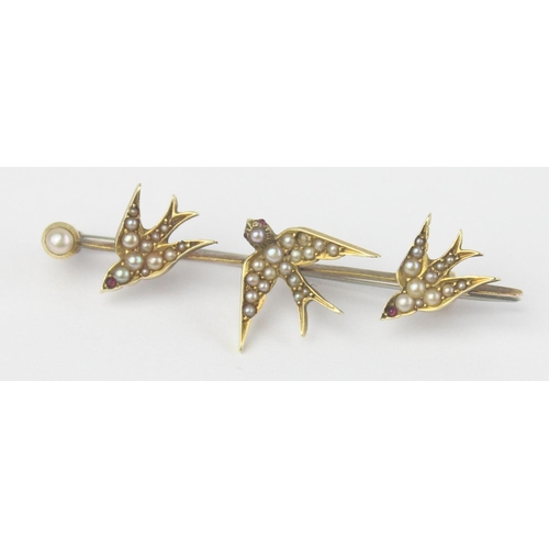 1130 - An antique 15ct gold bar brooch formed as a trio of swifts or swallows set with seed pearls, indisti... 