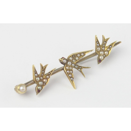 1130 - An antique 15ct gold bar brooch formed as a trio of swifts or swallows set with seed pearls, indisti... 