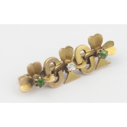 1152 - An antique 14ct gold bar brooch formed as chain interlocked 3 leaf clovers, a small central diamond ... 