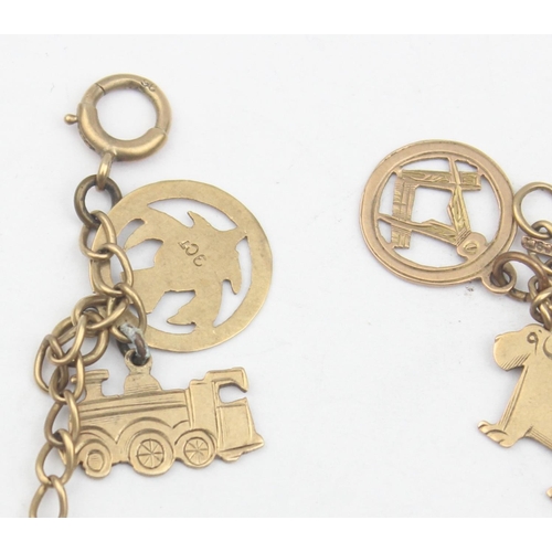 1154 - A vintage 9ct gold charm bracelet with a number of 9ct gold charms, some with enamel, to include tra... 