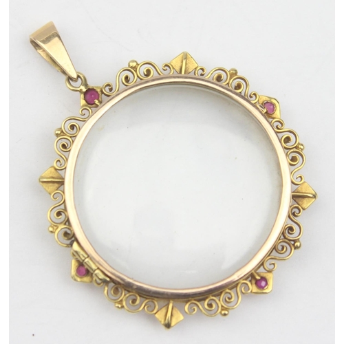 1157 - An antique yellow metal pendant locket set with seed pearls and rubies within a filigree border, see... 