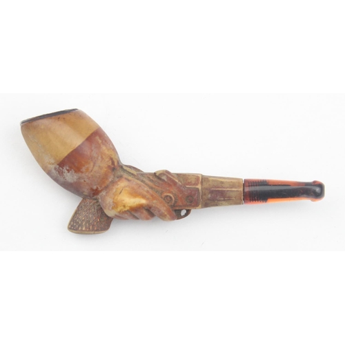 1532 - An antique carved meerschaum pipe in the form of a man holding a pistol, with amber mouthpiece, appr... 