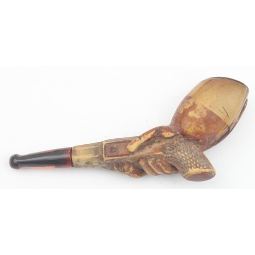 1532 - An antique carved meerschaum pipe in the form of a man holding a pistol, with amber mouthpiece, appr... 