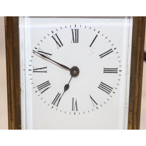 1327 - A vintage brass cased carriage clock with white enamel dial with Roman numerals, approx 11cm tall ex... 