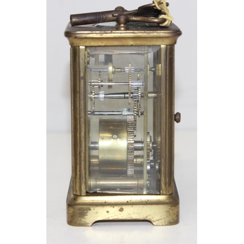 1327 - A vintage brass cased carriage clock with white enamel dial with Roman numerals, approx 11cm tall ex... 