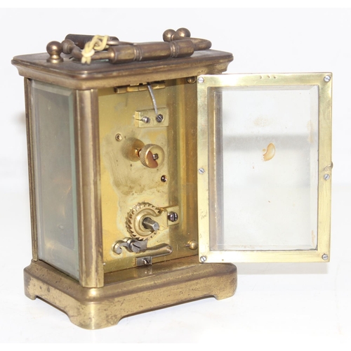 1327 - A vintage brass cased carriage clock with white enamel dial with Roman numerals, approx 11cm tall ex... 