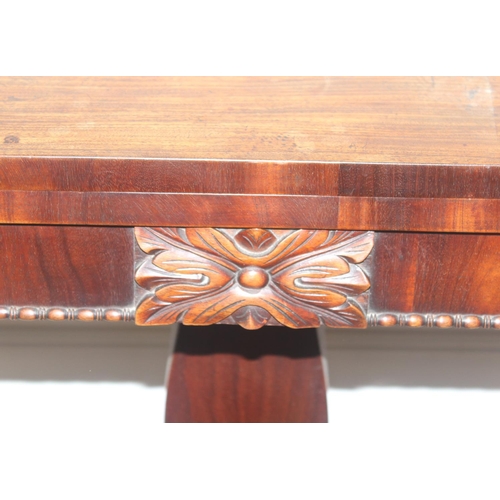 33 - A 19th century rosewood tea table with fold over top and lion paw feet on pillar base, approx 92cm w... 