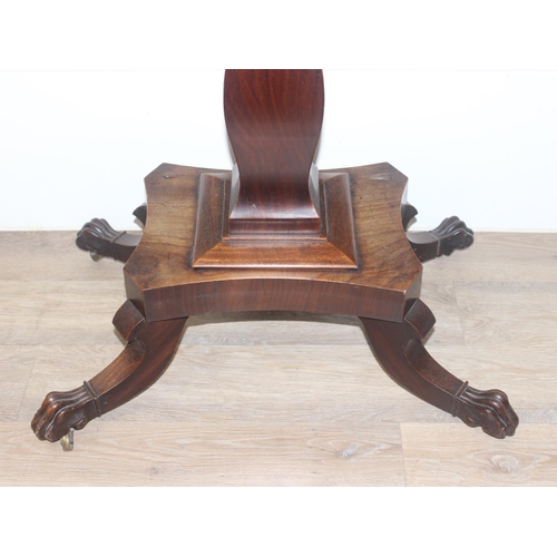 33 - A 19th century rosewood tea table with fold over top and lion paw feet on pillar base, approx 92cm w... 