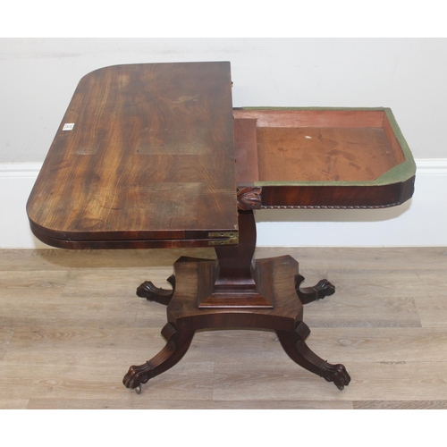 33 - A 19th century rosewood tea table with fold over top and lion paw feet on pillar base, approx 92cm w... 