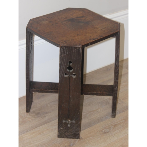 36 - An Arts & Crafts period oak side table in the manner of Liberty & Co, the legs with pierced design, ... 