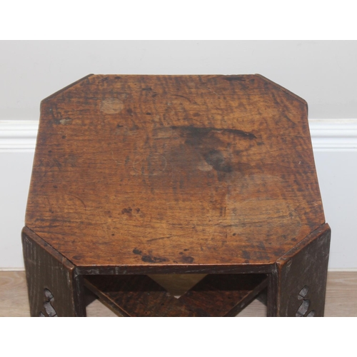 36 - An Arts & Crafts period oak side table in the manner of Liberty & Co, the legs with pierced design, ... 