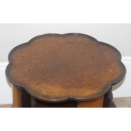 38 - A 1930's burr walnut topped revolving bookcase table with shaped top, approx 66cm wide x 56cm tall