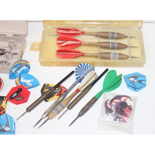 801 - Qty of vintage darts and accessories of varying size and weights to include flights and cases