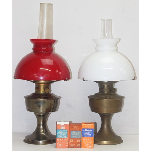 233 - 2 vintage oil lamps, one with red glass shade, the other white glass and 3 boxed NOS mantels, the la... 