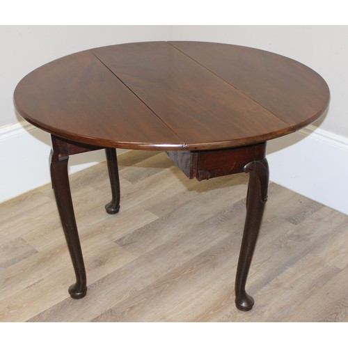 133 - An antique mahogany drop leaf table with carved legs and pad feet, approx 99cm wide x 36cm deep x 72... 