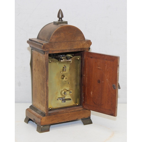 1328 - An unusual wooden cased carriage clock, the carriage clock movement with white enamel dial set withi... 