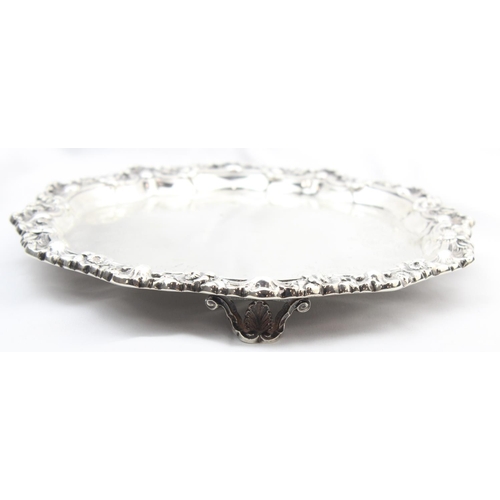 1064 - A large silver card tray with engraved decoration and floral cast border, indistinctly marked but XR... 