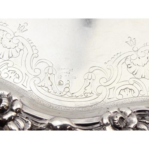 1064 - A large silver card tray with engraved decoration and floral cast border, indistinctly marked but XR... 