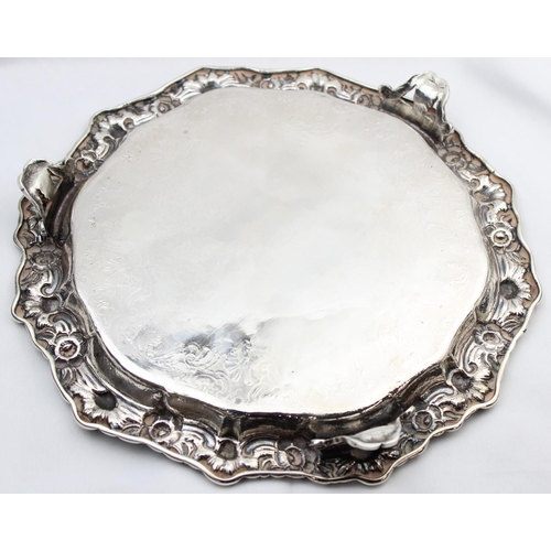 1064 - A large silver card tray with engraved decoration and floral cast border, indistinctly marked but XR... 