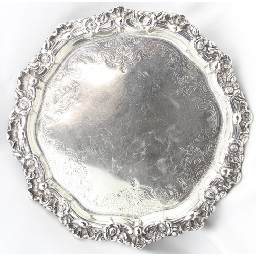 1064 - A large silver card tray with engraved decoration and floral cast border, indistinctly marked but XR... 