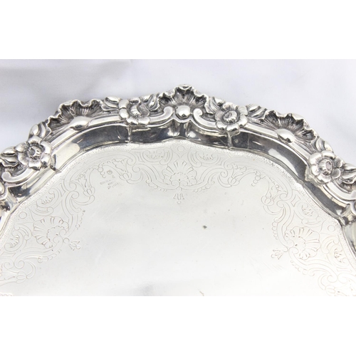 1064 - A large silver card tray with engraved decoration and floral cast border, indistinctly marked but XR... 