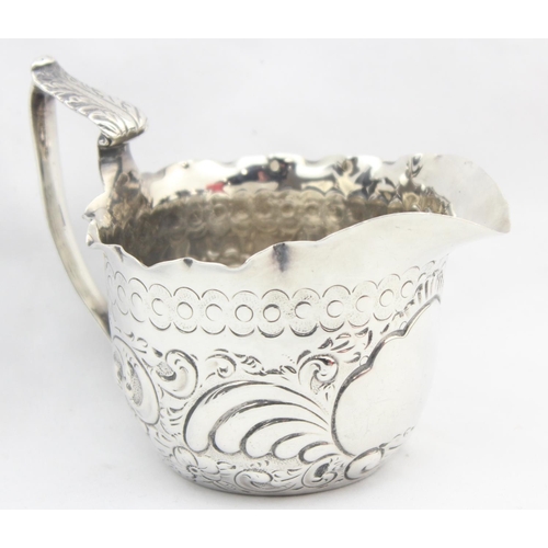 1066 - A Victorian silver cream jug with profuse embossed decoration, marked for London 1895 by Charles Edw... 