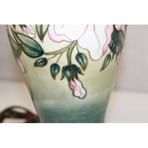 246 - A Moorcroft table lamp in the Hibiscus Moon pattern, with original shade, approx 58cm tall inc shade