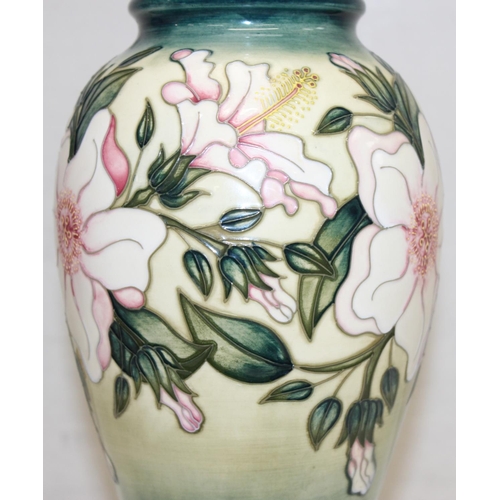 246 - A Moorcroft table lamp in the Hibiscus Moon pattern, with original shade, approx 58cm tall inc shade