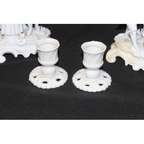 1521A - Nymphenburg pottery - A matched pair of Blanc-de-chine porcelain candlesticks decorated with classic... 