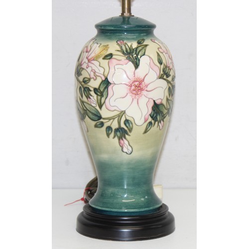 246 - A Moorcroft table lamp in the Hibiscus Moon pattern, with original shade, approx 58cm tall inc shade