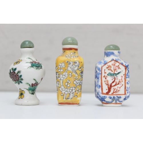 1479 - 3 assorted Chinese porcelain snuff bottles on wooden stand, all with polychrome decoration, the larg... 