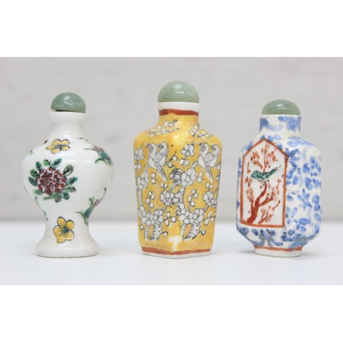 1479 - 3 assorted Chinese porcelain snuff bottles on wooden stand, all with polychrome decoration, the larg... 