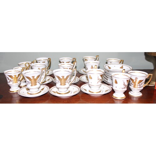 1567 - An extensive qty of Limoges gilt decorated coffee cups and saucers, decorated in the Napoleonic peri... 