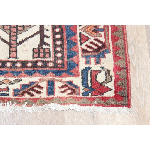 211 - A large vintage Bakhtiari rug of red ground, with decorative squared panels, approx 240cm x 140cm