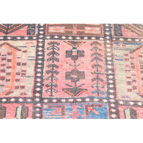 211 - A large vintage Bakhtiari rug of red ground, with decorative squared panels, approx 240cm x 140cm