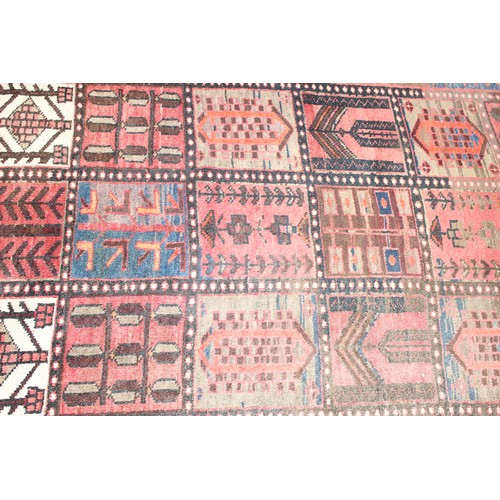 211 - A large vintage Bakhtiari rug of red ground, with decorative squared panels, approx 240cm x 140cm