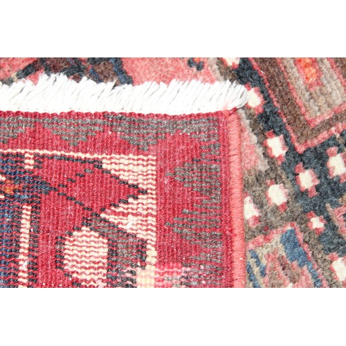 211 - A large vintage Bakhtiari rug of red ground, with decorative squared panels, approx 240cm x 140cm