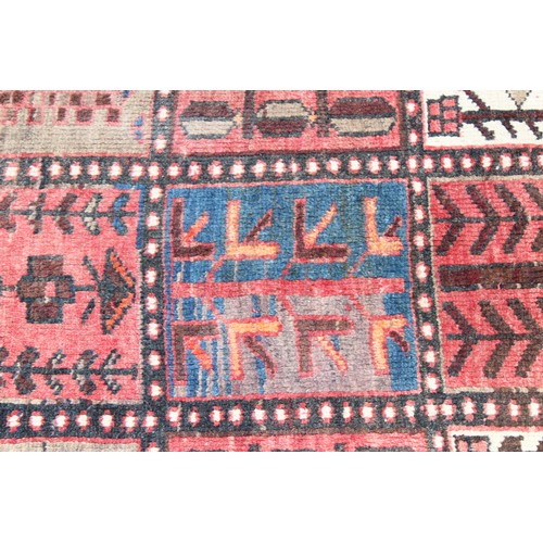 211 - A large vintage Bakhtiari rug of red ground, with decorative squared panels, approx 240cm x 140cm