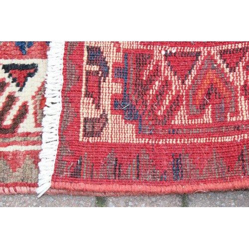 211 - A large vintage Bakhtiari rug of red ground, with decorative squared panels, approx 240cm x 140cm