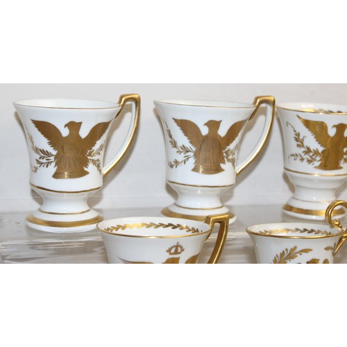 1567 - An extensive qty of Limoges gilt decorated coffee cups and saucers, decorated in the Napoleonic peri... 