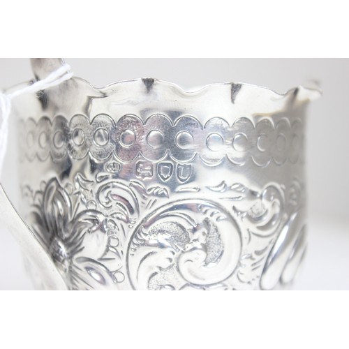 1066 - A Victorian silver cream jug with profuse embossed decoration, marked for London 1895 by Charles Edw... 